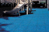 Rubber tiles with play structure in background